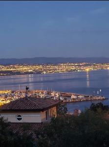 a view of a harbor with a marina at night at " Rooms Bela" balcony in Ičići