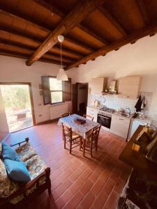 a living room with a table and a kitchen at Agriturismo “Sterrati” in Valpiana +49 photos