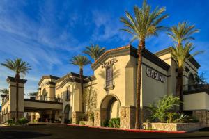 a building with palm trees in front of it at Silver Sevens Hotel and Casino, a Wyndham Garden in Las Vegas