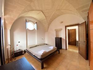 a bedroom with a bed in a room with a ceiling at Comfortable House with Fenced Garden - Surano - Fireplace in Surano