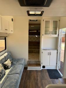 a living room of a tiny house with a couch at RV2 Stunning RV Private Netflix FreeParking in Moreno Valley