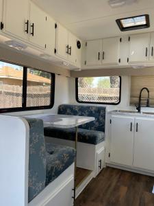 an rv kitchen with white cabinets and a sink at RV2 Stunning RV Private Netflix FreeParking in Moreno Valley