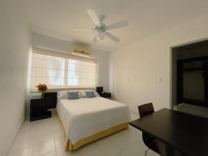a bedroom with a bed and a ceiling fan at L`aurora Hotel Boutique in Yopal
