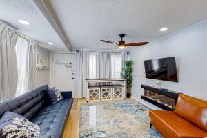 a living room with a couch and a television at The Quarterdeck OC in Ocean City