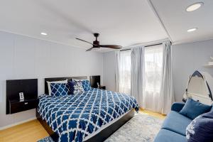 a bedroom with a blue bed and a blue couch at The Quarterdeck OC in Ocean City