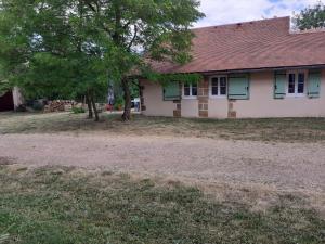 Una casa vieja con un árbol delante. en Gîte Neuvy, 2 pièces, 2 personnes - FR-1-489-10 en Neuvy