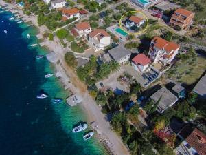 an island with houses and boats in the water at House Osti in Rogoznica