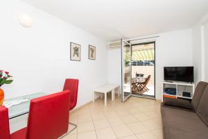 a living room with a couch and a table at Apartment Pave by Zamalin beach in Tribunj