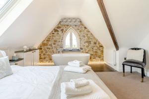 a bedroom with a large bed and a bath tub at Rhodewood Lodge in Saundersfoot