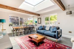 a living room with a blue couch and a table at Rhodewood Lodge in Saundersfoot