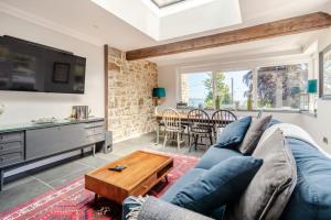 a living room with a blue couch and a table at Rhodewood Lodge in Saundersfoot