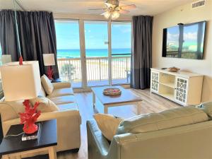 a living room with a view of the ocean at Pelican Beach 2 bedroom 4th floor Gulf Front Condo in Destin