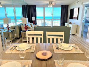 a living room with a table with chairs and a couch at Pelican Beach 2 bedroom 4th floor Gulf Front Condo in Destin