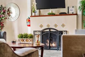 a living room with a fireplace and a table at Oceanside Rocks Family Vacation Home in Oceanside