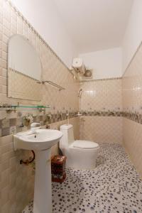 a bathroom with a sink and a toilet at Tam Coc Mountain Lake Homestay in Ninh Binh +53 photos