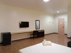 a room with a flat screen tv on a wall at Meaco Royal Hotel- Lucena in Lucena