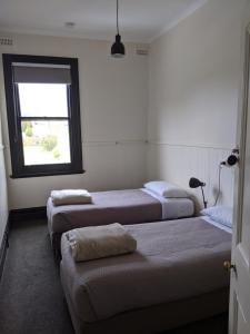 drie bedden in een kamer met een raam bij The Dorset Hotel in Derby