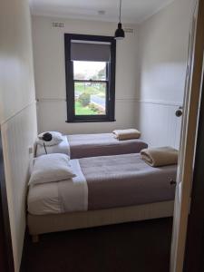 two beds in a room with a window at The Dorset Hotel in Derby