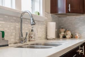 a kitchen counter with a sink in a kitchen at Oceanside Rocks Family Vacation Home in Oceanside +40 photos