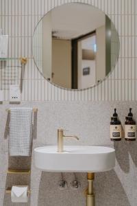 a bathroom with a sink and a mirror at Aerotel Sydney (Arrivals B, International Terminal 1) in Sydney