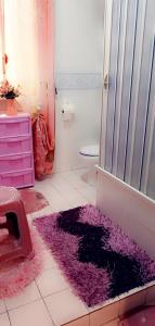 a bathroom with a pink and purple rug on the floor at Bed fiorella in Acciaroli