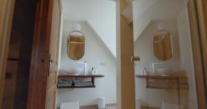 a bathroom with two sinks and two mirrors on the wall at Berkies - autonome studio in Steenokkerzeel +10 photos