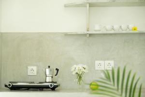 a kitchen counter with a blender and a vase of flowers at Anatoli in Ambelas