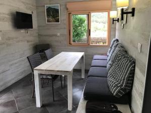 a living room with a table and a couch at La Croix du Sud 2 - Bas de Villa Cilaos in Cilaos