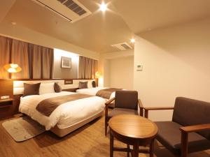 Postel nebo postele na pokoji v ubytování Tottori Onsen Hotel Monarque Tottori