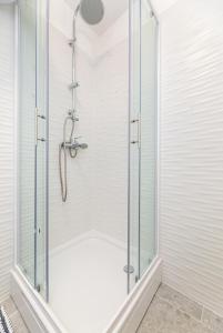 a shower with a glass door in a bathroom at Apartments Riva in Baška +30 photos