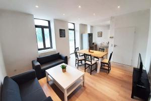 a living room with a couch and a table at Work & Stay Apartment in Stolberg bei Aachen in Stolberg