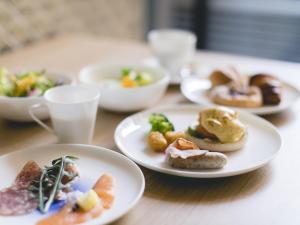 a table with plates of food on a table at THE THOUSAND KYOTO in Kyoto