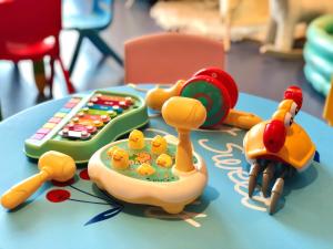 a toy train on a table next to a remote control at Ascott M-City Foshan in Foshan