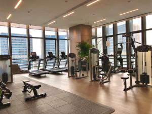 a gym with treadmills and machines in a building at Ascott M-City Foshan in Foshan