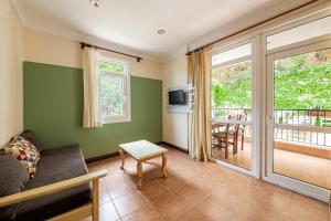 a living room with a couch and a balcony at Lantana Aparts in Kaş