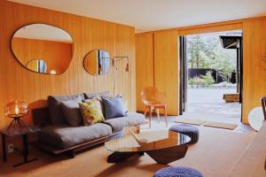 a living room with a couch and a glass table at HOTEL KEYFOREST HOKUTO in Hokuto