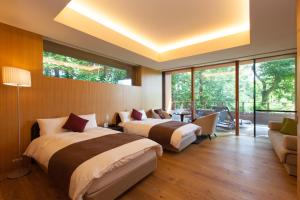 Postel nebo postele na pokoji v ubytování HOTEL KEYFOREST HOKUTO