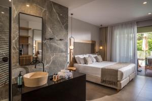 a hotel room with a bed and a bathroom at Stella Palace Aqua Park Resort in Hersonissos