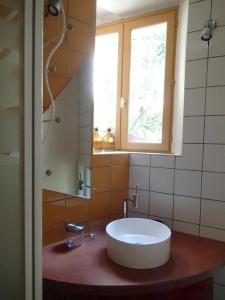 a bathroom with a white sink and a window at Le gite de l'impassiflore in Méounes-lès-Montrieux +17 photos