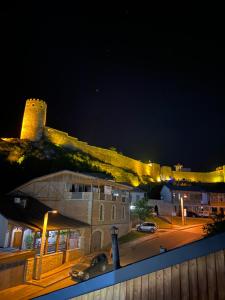 a building with a car parked on a street at night at Millennium Rabati in Akhaltsikhe