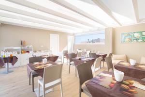 a restaurant with tables and chairs in a room at B&B Rais Luxury Rooms in Vieste