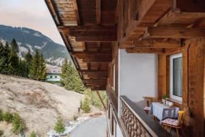 a balcony with a table and a view of a mountain at A. Paolo Apartments in Vigo di Fassa