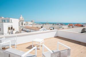 a balcony with chairs and a view of the city at B&B Rais Luxury Rooms in Vieste