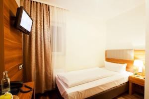 Hotel Frankfurt Messe客房内的一张或多张床位