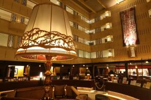a lobby of a hotel with a large light fixture at Kyoto Century Hotel in Kyoto