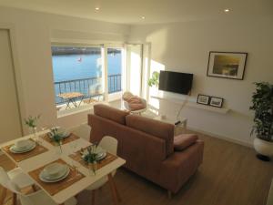 uma sala de estar com um sofá e uma mesa em Apartamento Na Beira Do Mar em O Pindo