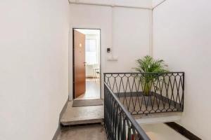 un corridoio con scala con una pianta in vaso di Anita's Apartment a Como