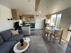 a living room with a couch and a table at Dammhuis Zeeland in Oostkapelle