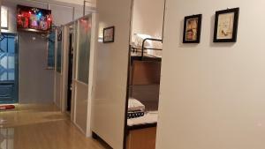 a room with a hallway with bunk beds in it at Sky House Hostel in Ho Chi Minh City