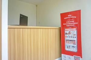 a reception desk with a sign in a room at Super OYO 91139 Skyland Bogorienze Apartment in Bogor
